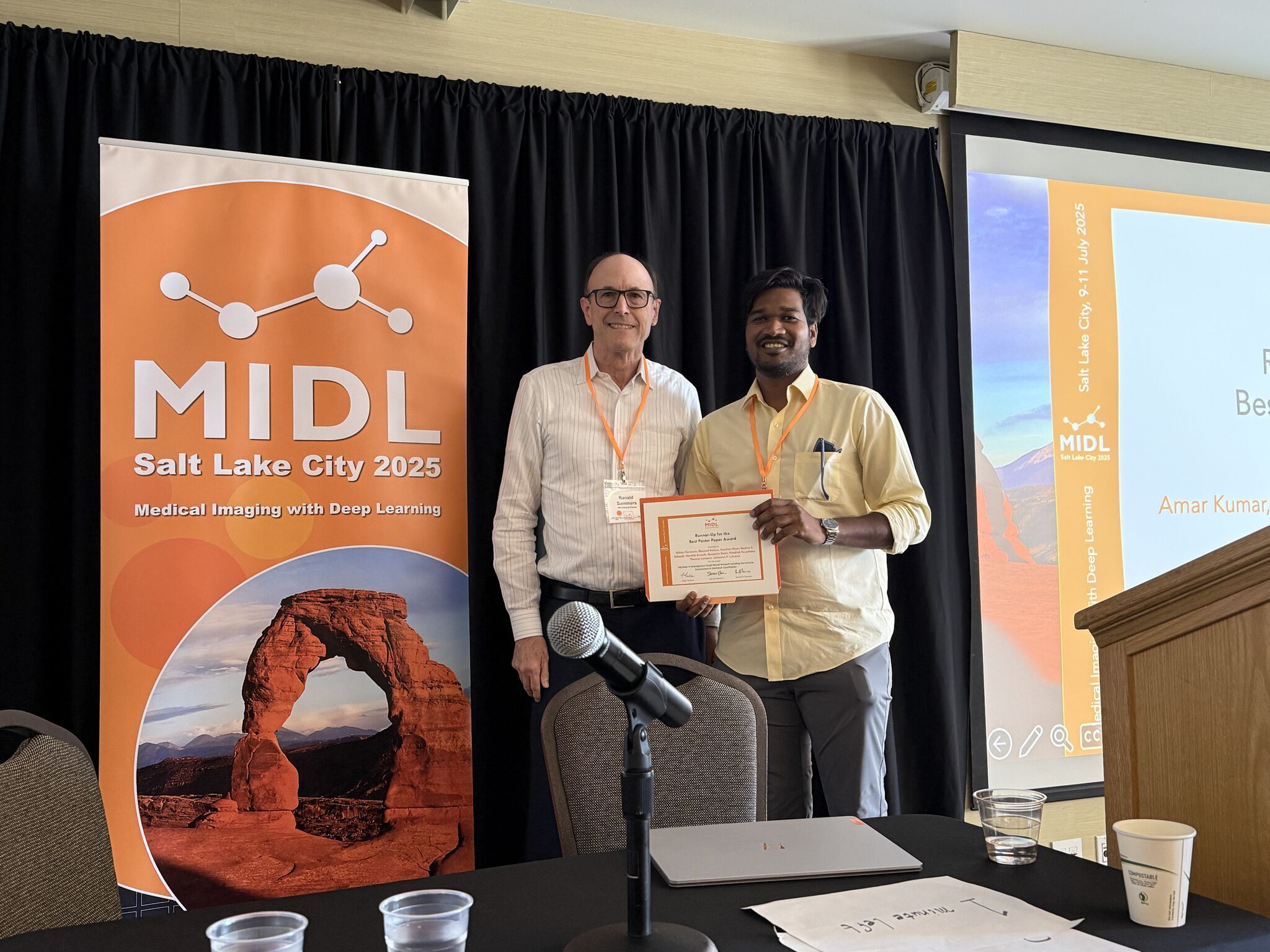 Amar Kumar receiving the runner-up for best oral paper award at MIDL 2025